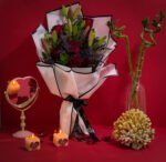Valentine’s bouquet of red roses with lilies and limonium wrapped in white by Flowsent – flower delivery in Cairo and Giza